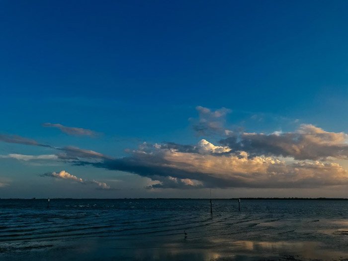 Una foto oscura de una nube sobre un paisaje marino