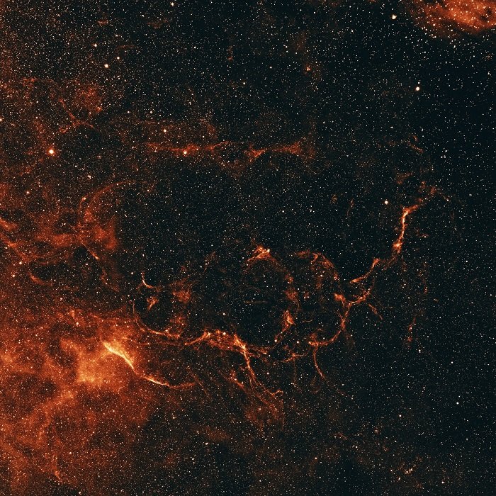 una imagen del cielo nocturno con nebulosas naranjas